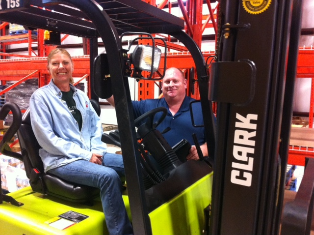 Sharon Jones of the Community Food Bank of Citrus County sits in the Clark TMX15S, one of two forklifts the Food Bank recently purchased from Ring Power Lift Trucks.