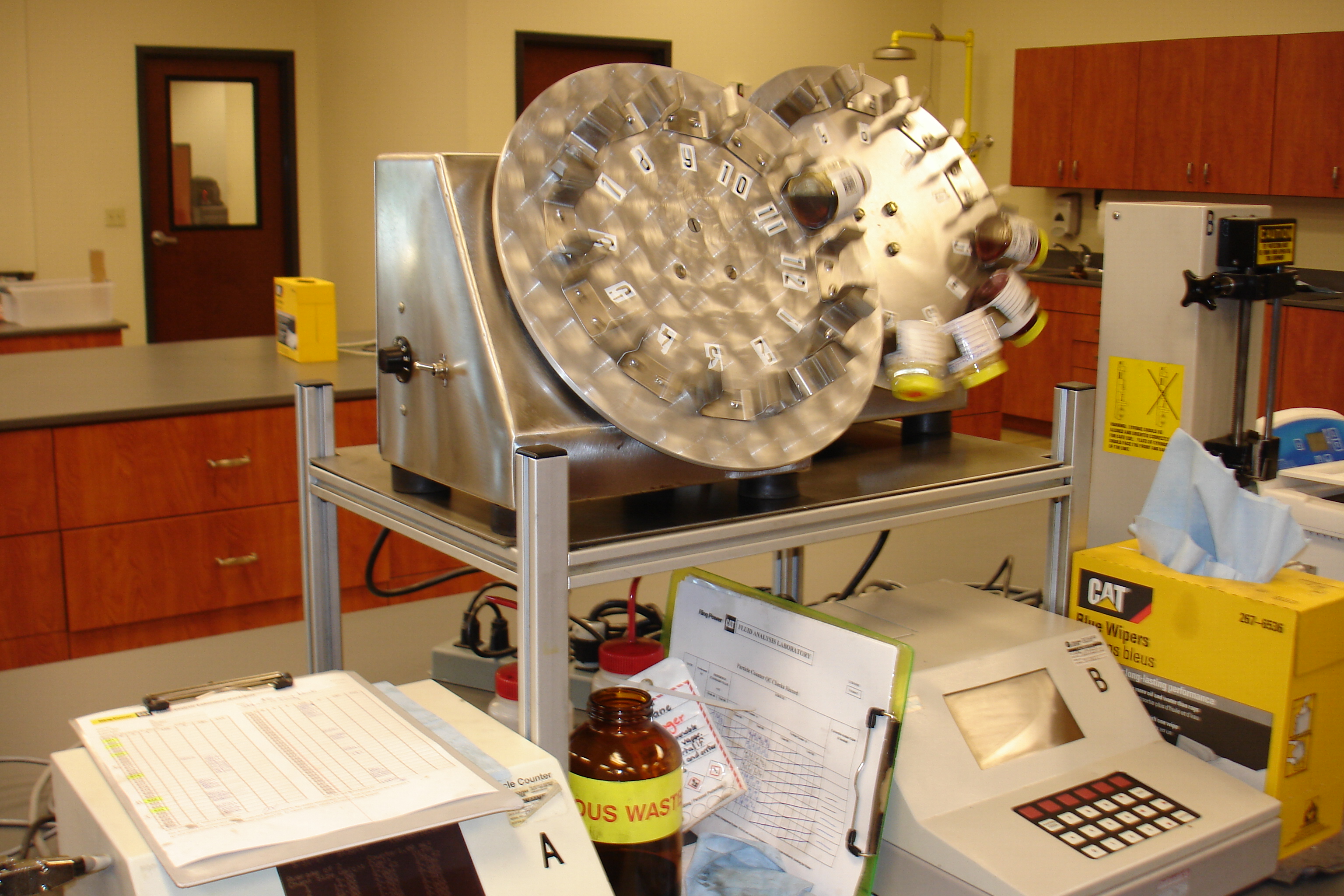 Two rotation wheels gently disperse the particles throughout the sample before particle count testing.
