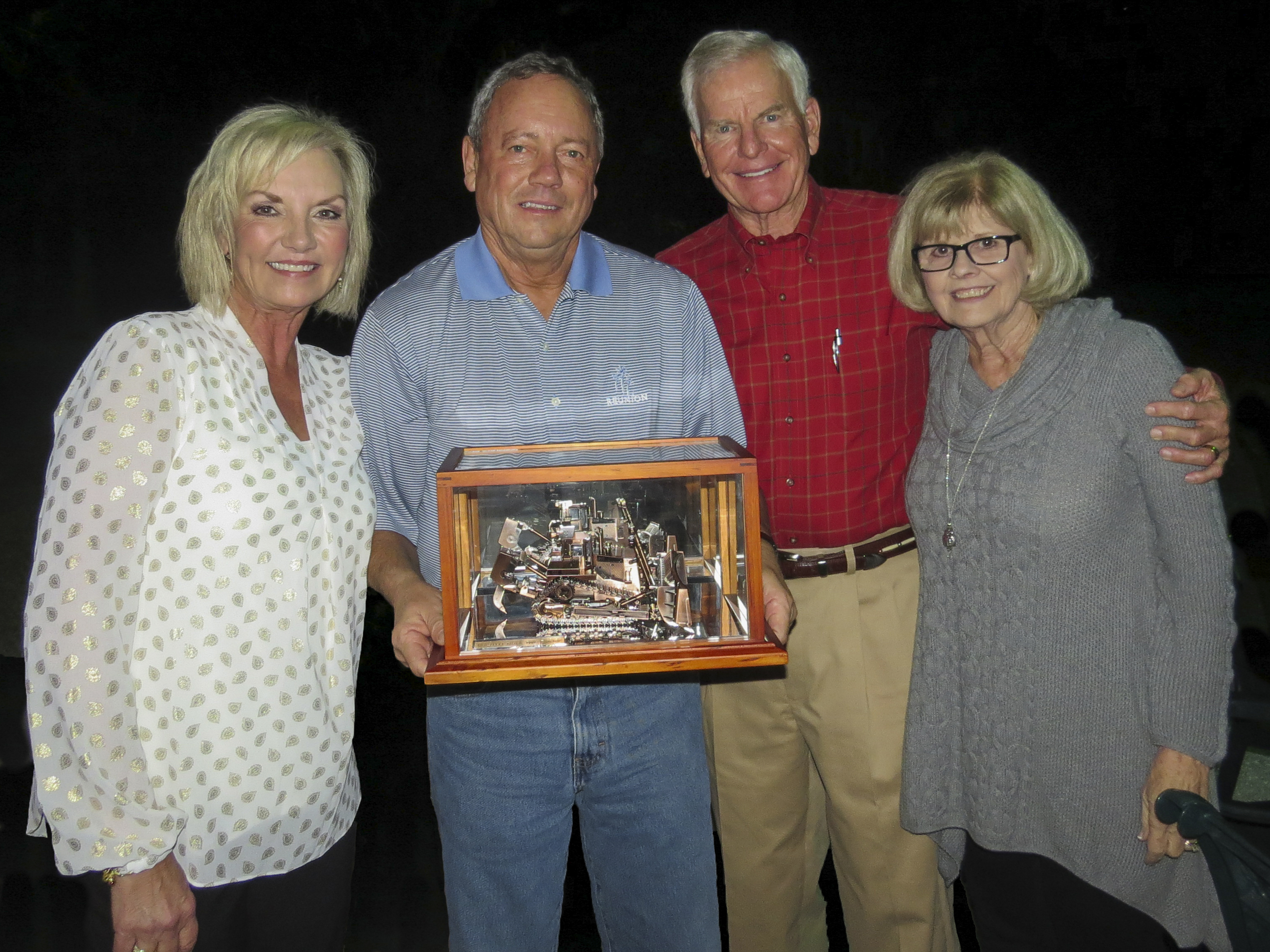- Paula Ringhaver, Frank Fowler, Randy Ringhaver, & Lynne Fowler are pictured at a board of directors meeting where Frank Fowler was presented with a commemorative collector model Cat D11T tractor.  